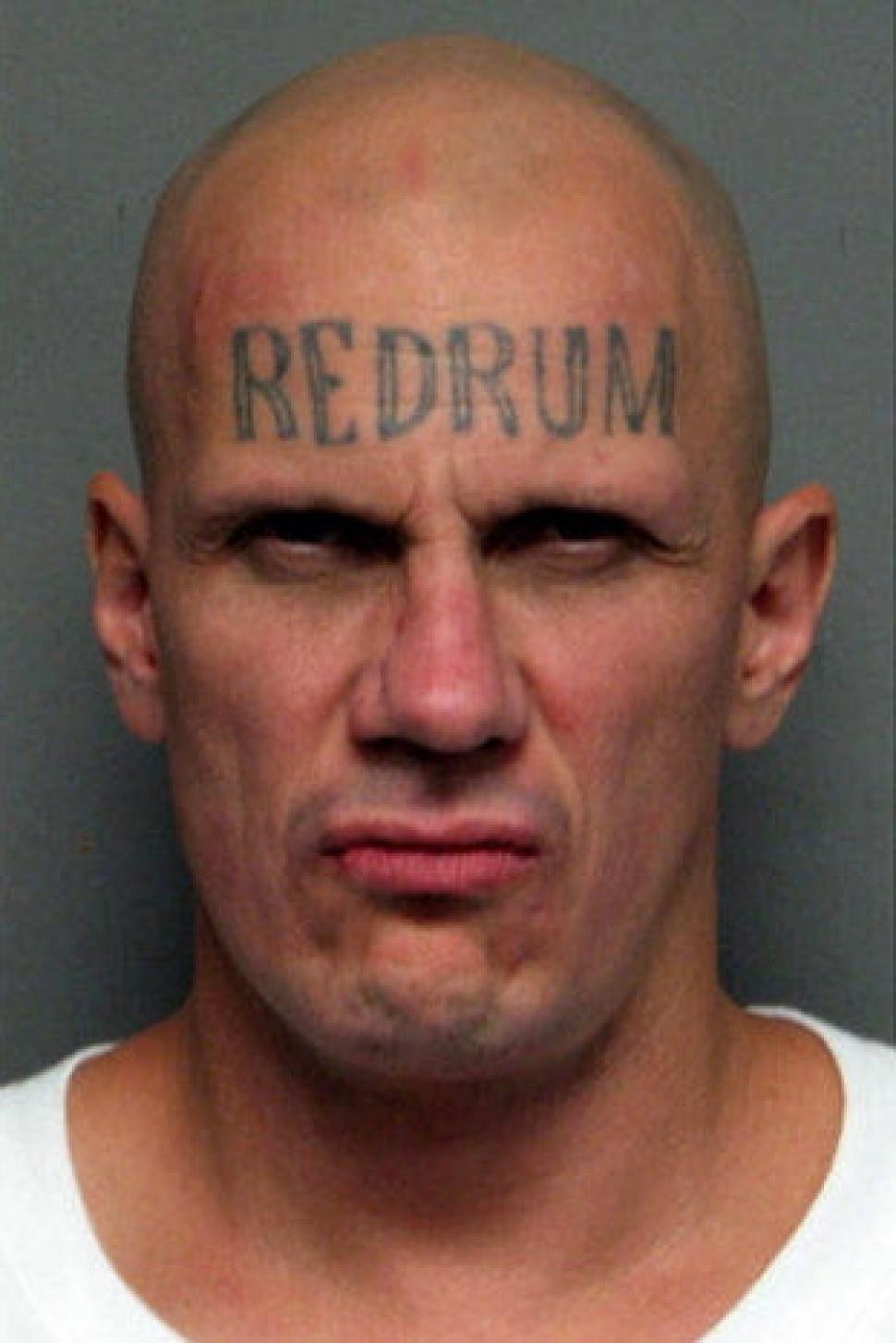 Red Drum Tattoo On Man Forehead