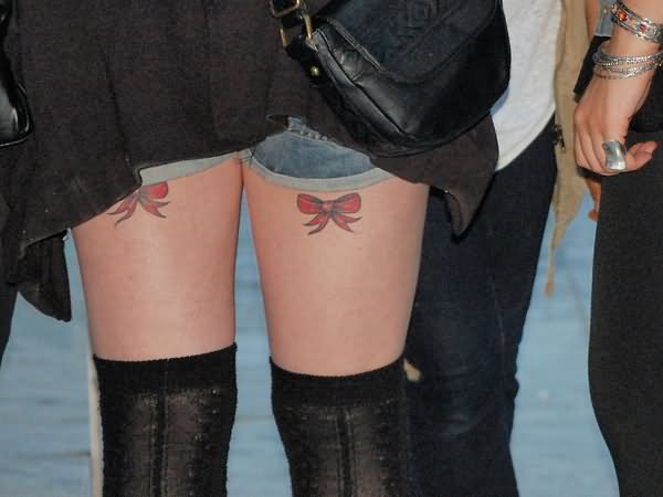 Red Ribbon Bow Tattoo On Both Back Leg
