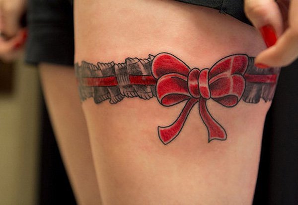 Red Ribbon Bow Tattoo On Girl Thigh