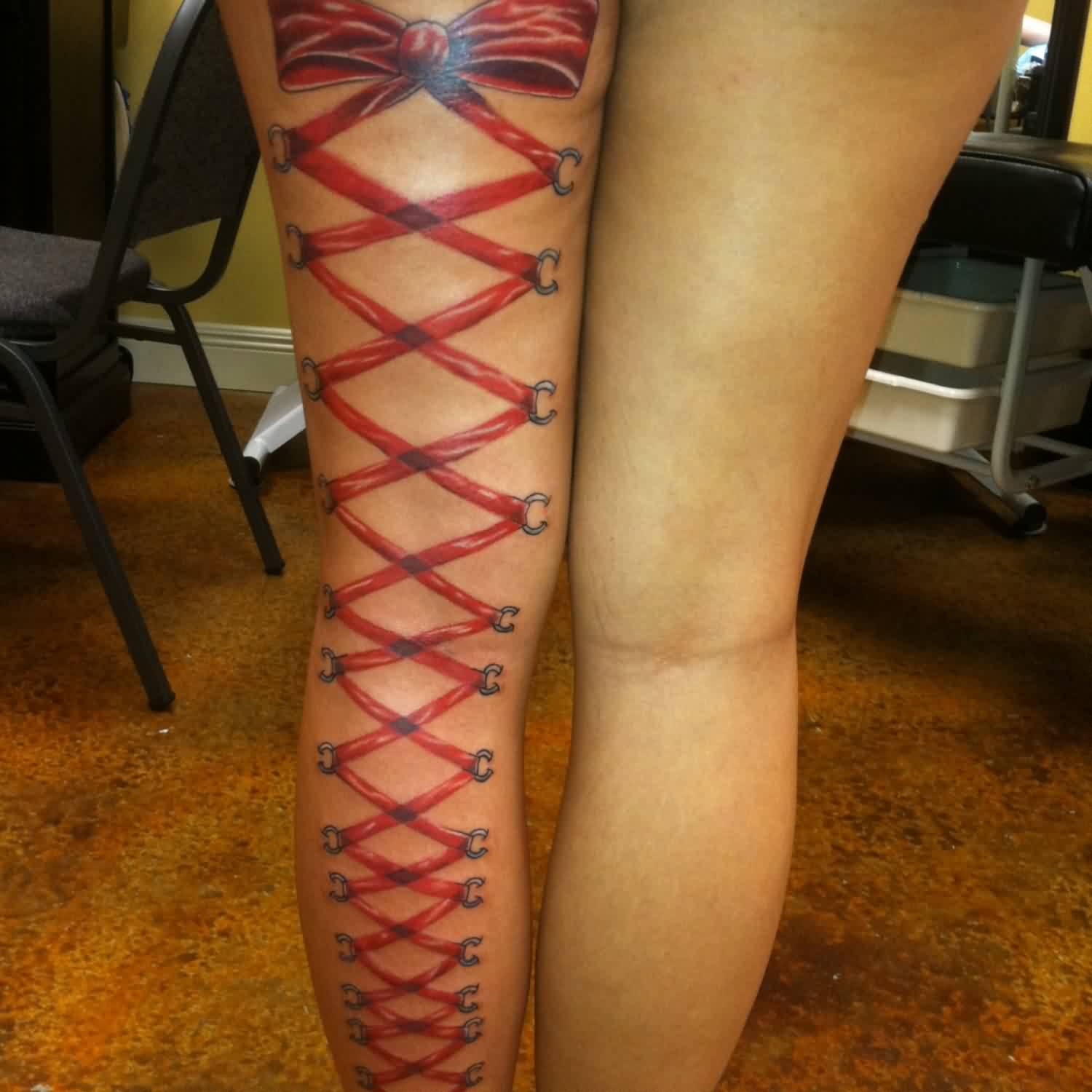 Red Ribbon Corset Bow Tattoo On Full Leg