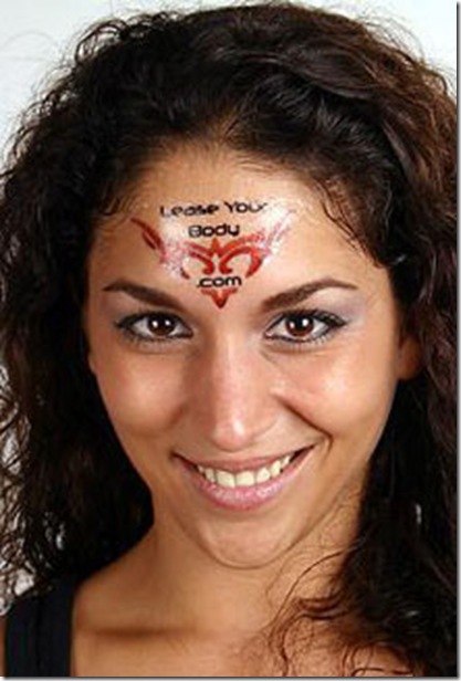 Red Tribal Tattoo On Girl Forehead