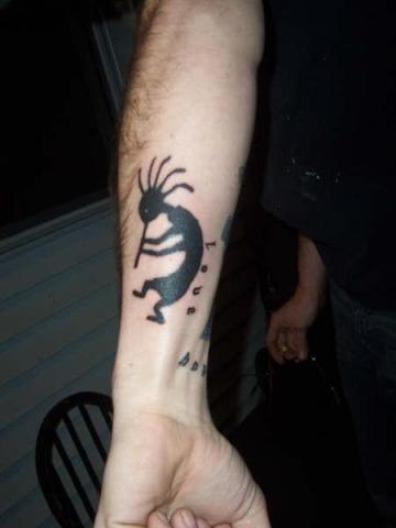 Silhouette Kokopelli Tattoo On Forearm