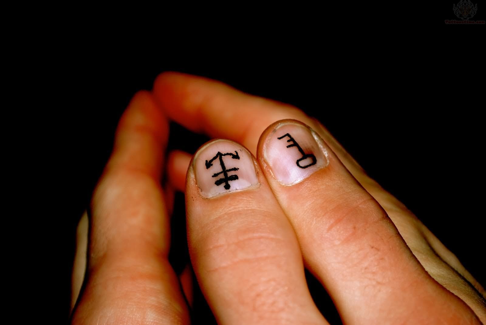 Simple Black Key And Anchor Tattoo On Both Thumb Nail