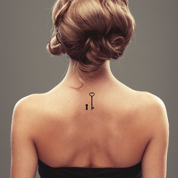 Simple Black Key With Key Hole Tattoo On Girl Upper Back
