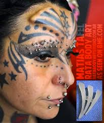 Stars And Tribal Tattoo On Forehead