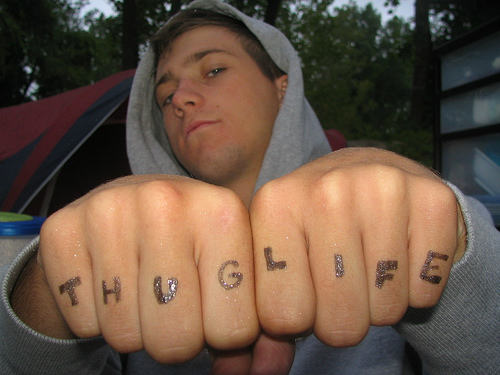 Thug Life Lettering Tattoo On Man Both Hand Fingers