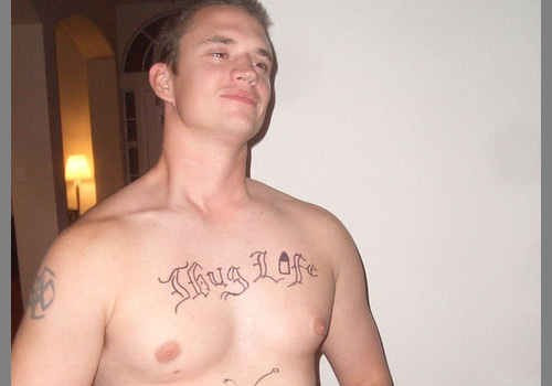 Thug Life Lettering With Bullet Tattoo On Man Chest