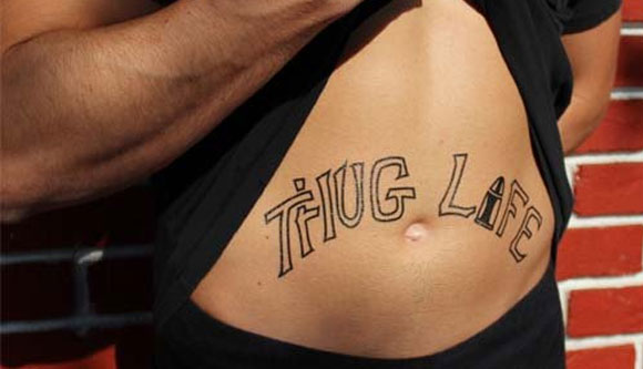 Thug Life Lettering With Bullet Tattoo On Man Stomach