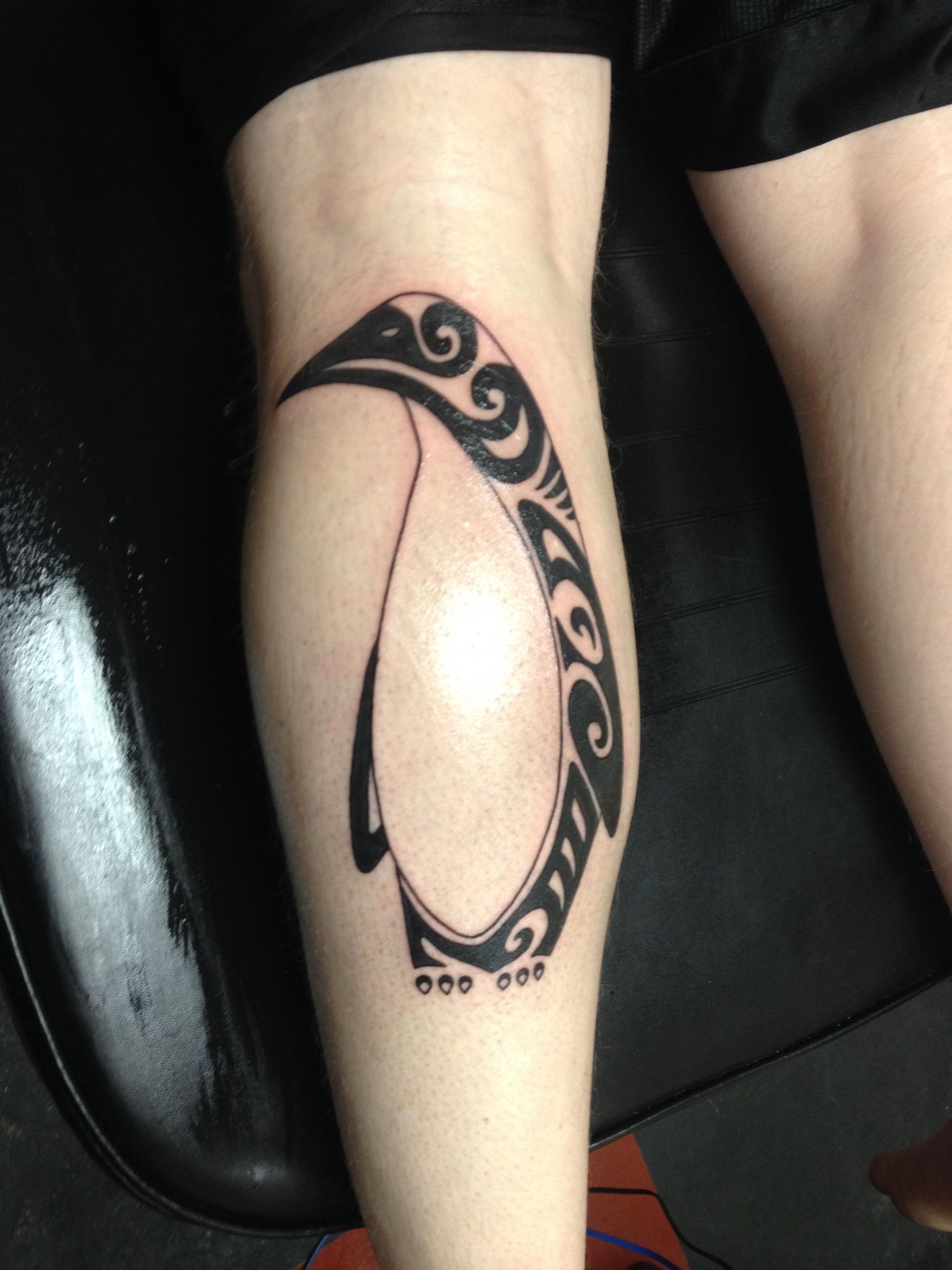 Tribal Penguin Tattoo On Back Leg