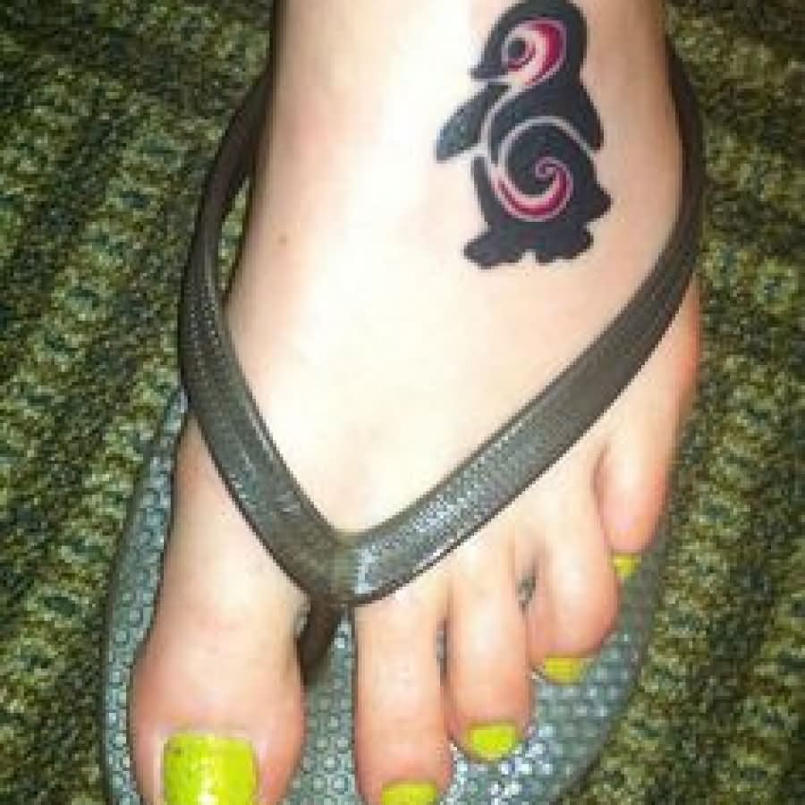 Tribal Spiral Penguin Tattoo On Girl Left Foot