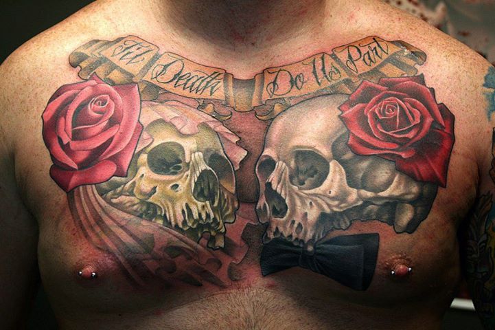 Two Death Skull With Roses And Banner Tattoo On Man Chest