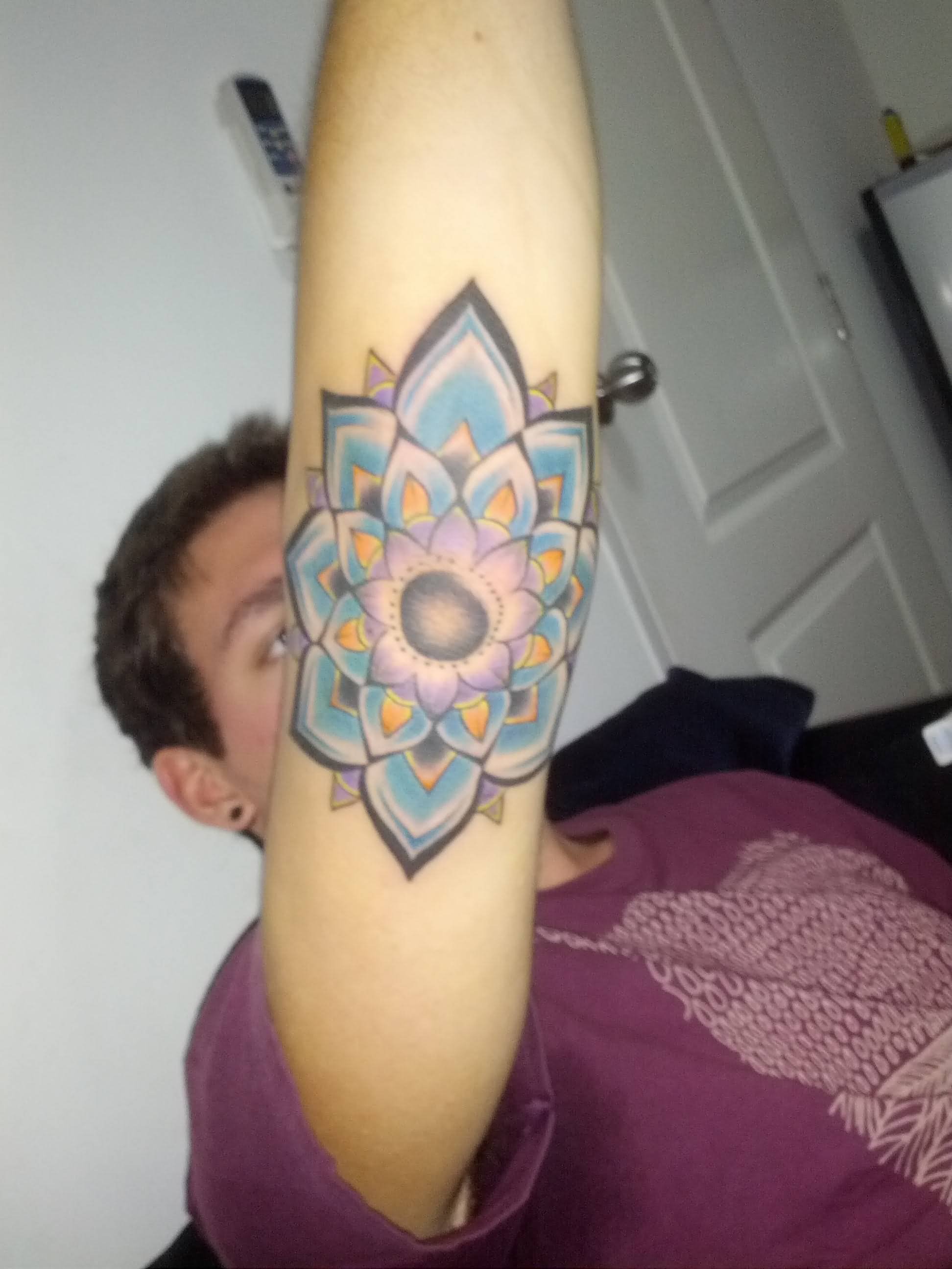 Awesome Colorful Flower Tattoo On Man Right Elbow