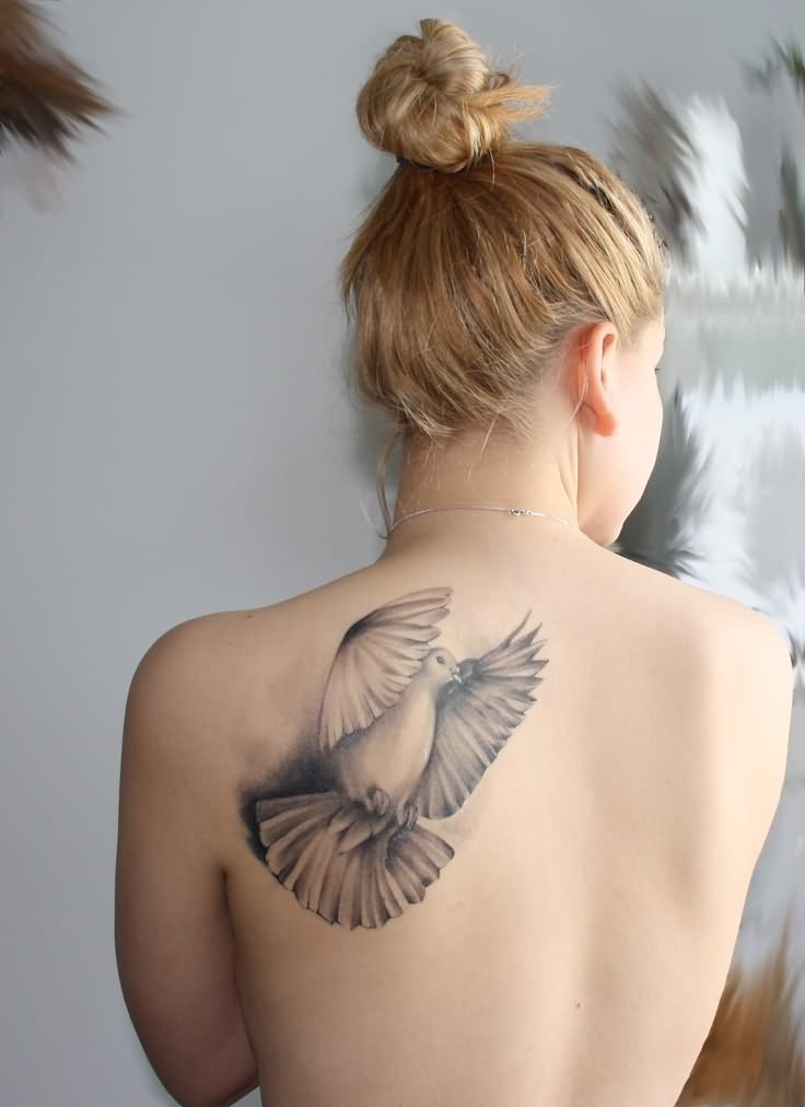 Black And Grey Flying Pigeon Tattoo On Girl Left Back Shoulder