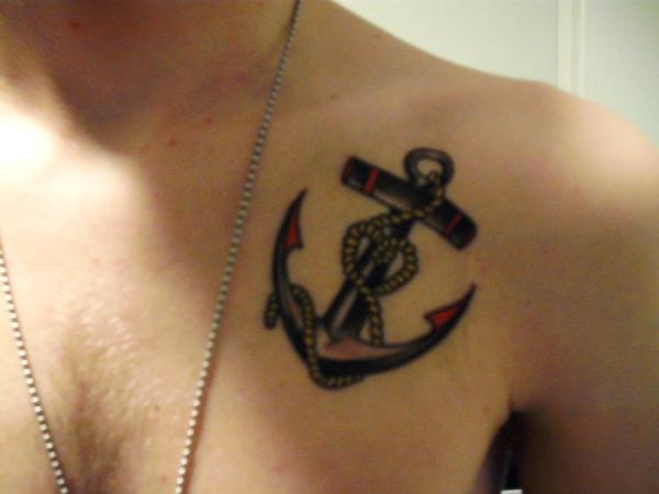 Black Ink Anchor With Rope Knot Tattoo On Man Left Front Shoulder