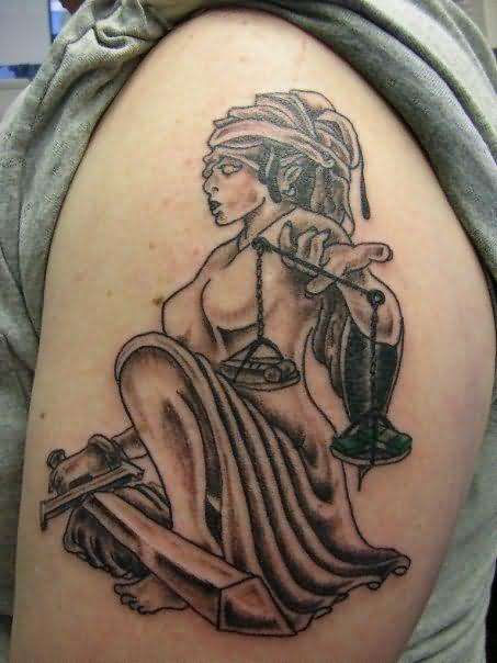 Black Ink Justice Scale And Sword In Lady Hand Tattoo On Shoulder
