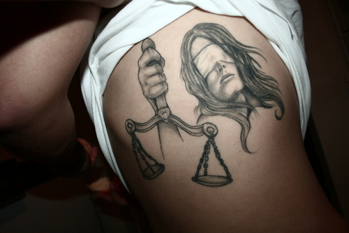 Black Ink Justice Scale In Girl Hand Tattoo Design