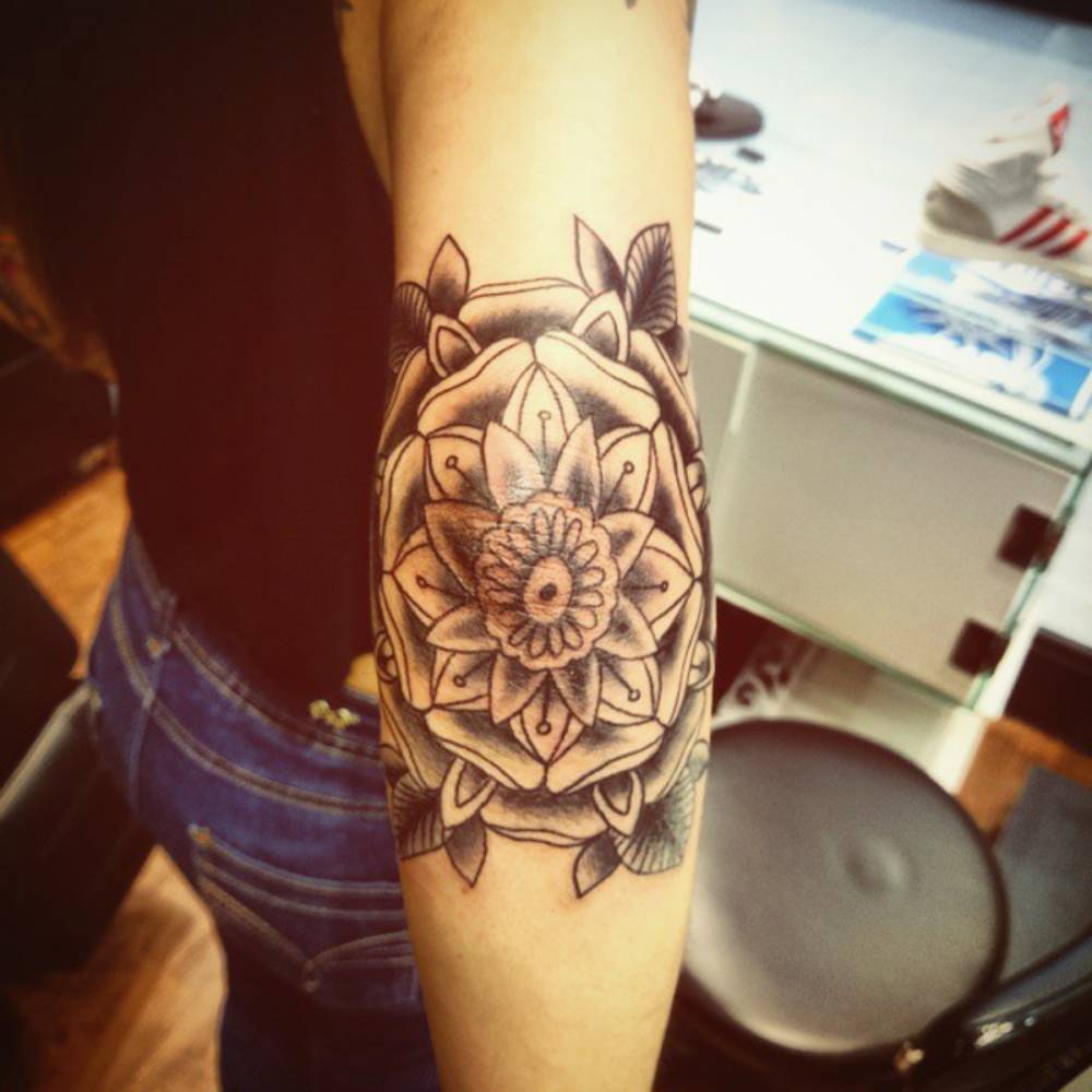 Black Ink Mandala Flower Tattoo On Girl Right Elbow