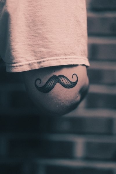 Black Ink Moustache Tattoo Design For Elbow