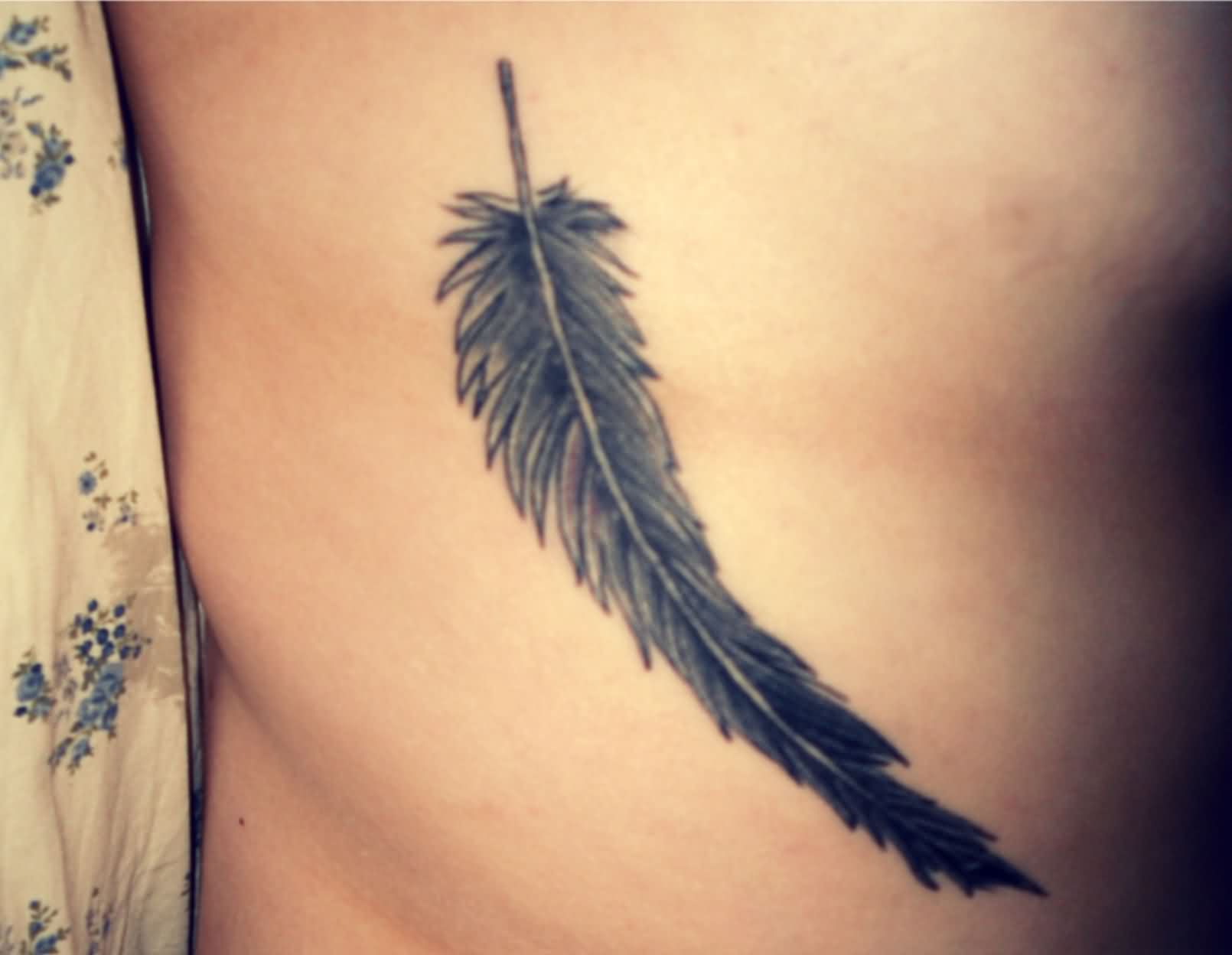 Black Ink Pigeon Feather Tattoo Design For Side Rib