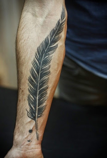 Black Ink Pigeon Feather Tattoo On Forearm