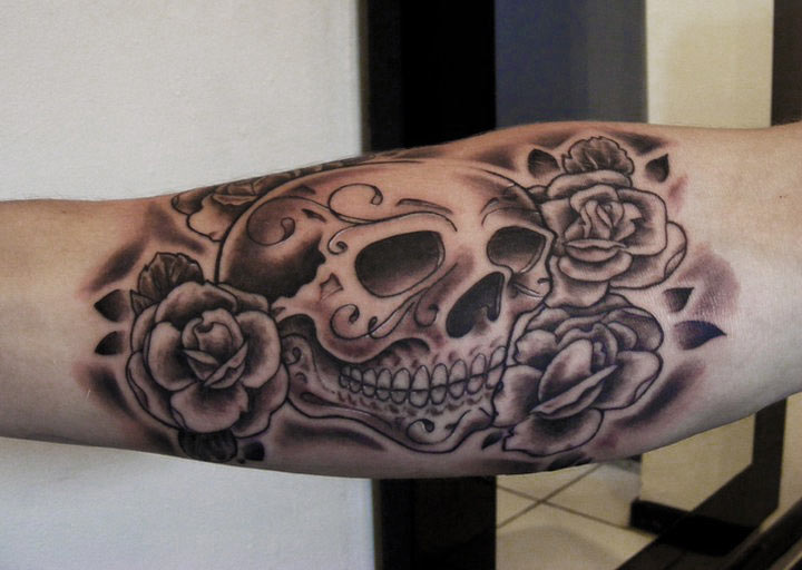 Black Ink Skull With Roses Tattoo Design For Elbow
