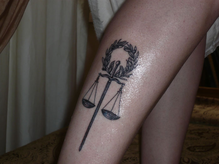 Black Ink Sword Justice Scale Tattoo On Leg