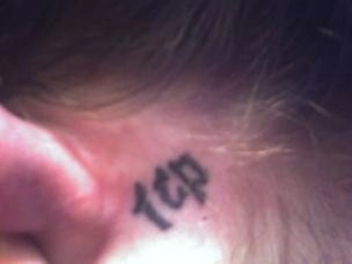 ICP Lettering Tattoo On Girl Behind The Ear