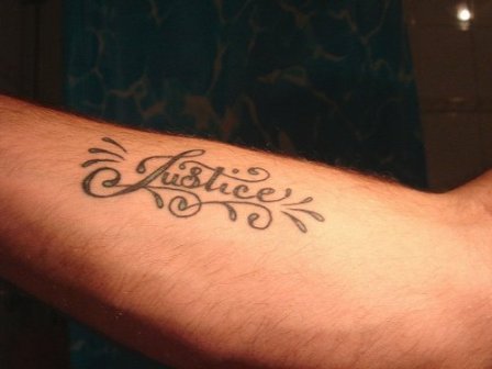 Justice Lettering Tattoo On Forearm