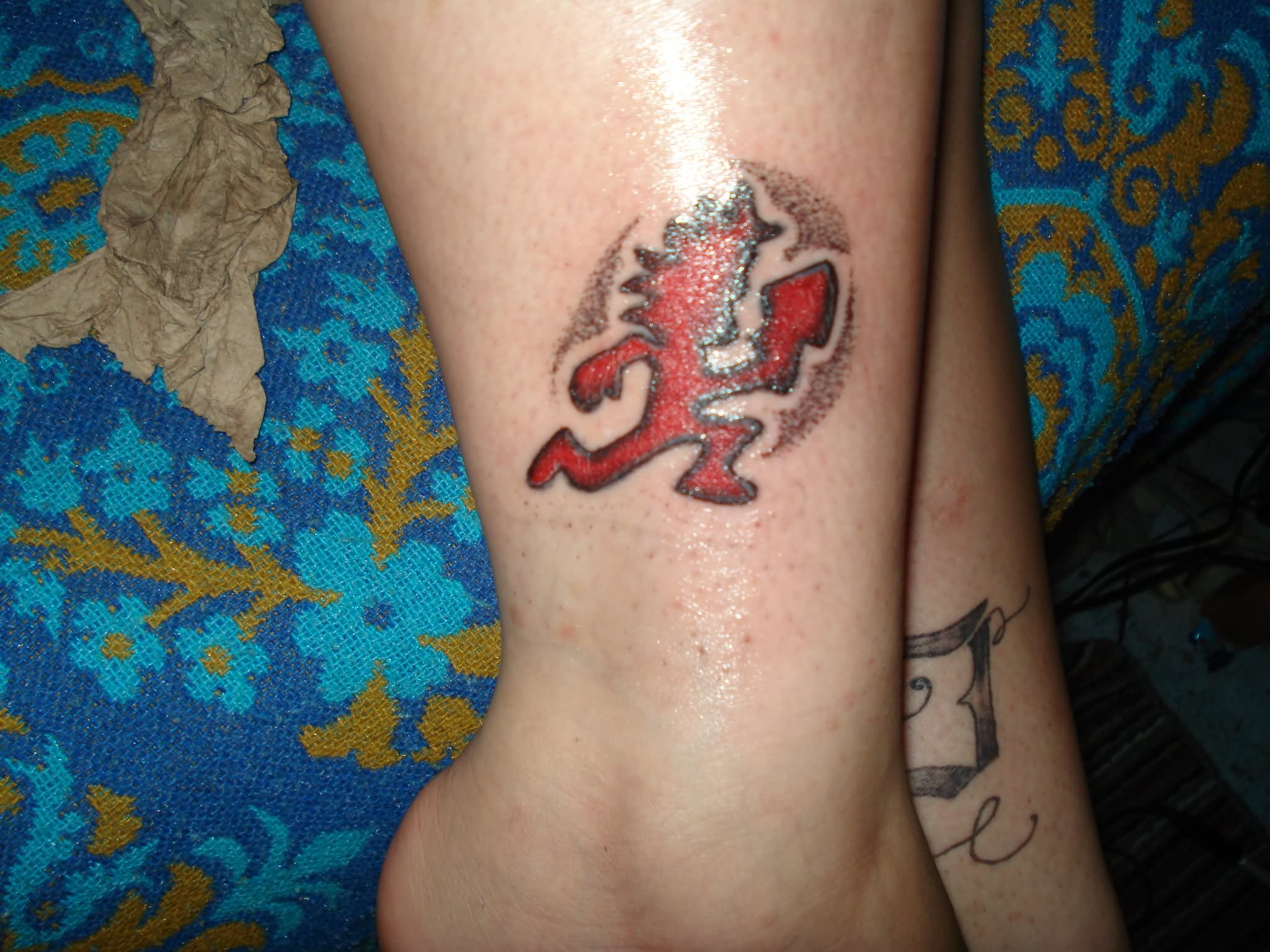 Red Hatchetman Tattoo On Leg