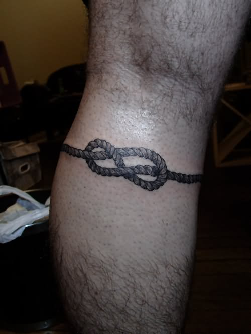 Simple Black Ink Rope Knot Tattoo On Leg Calf