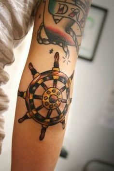 Traditional Sailor Wheel Tattoo On Right Elbow