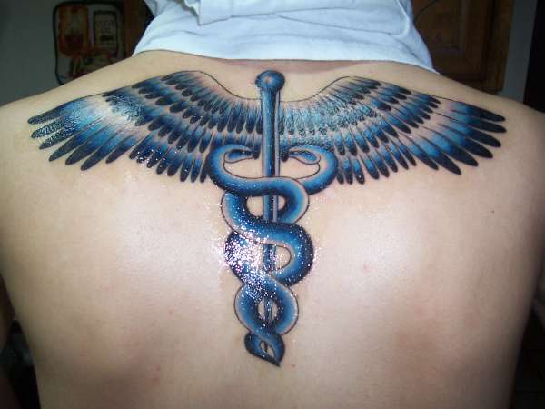 Black And Blue Medical Symbol Tattoo On Upper Back