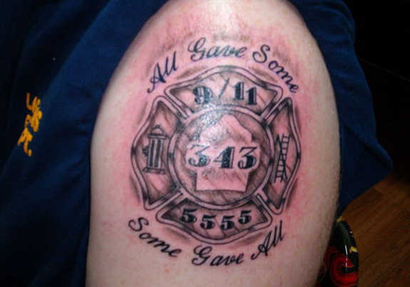 Black And Grey Firefighter Cross Tattoo Design For Shoulder