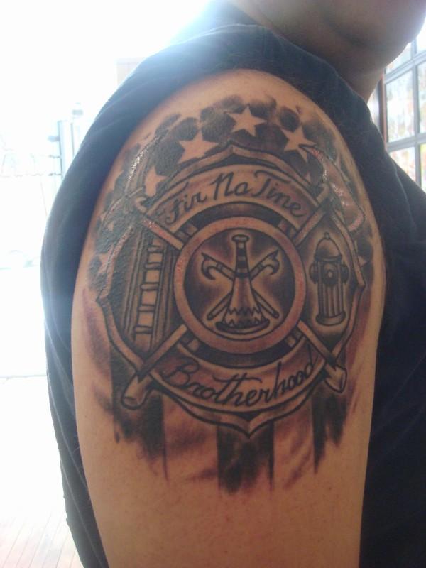 Black And Grey Firefighter Logo Tattoo On Right Shoulder