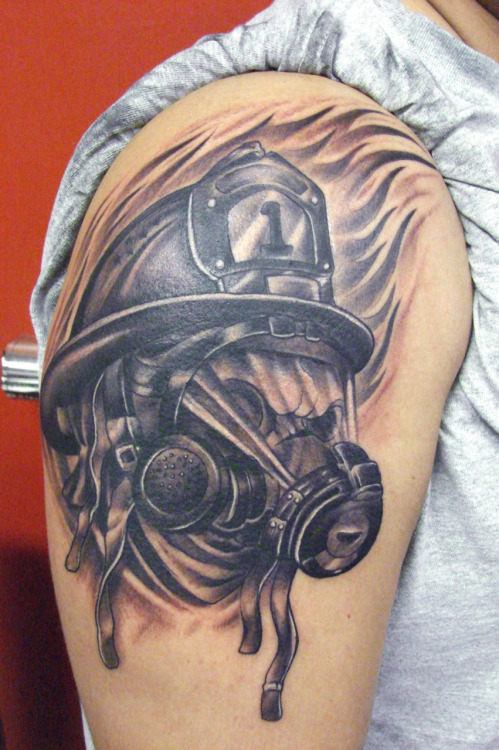 Black And Grey Firefighter Mask Tattoo On Shoulder