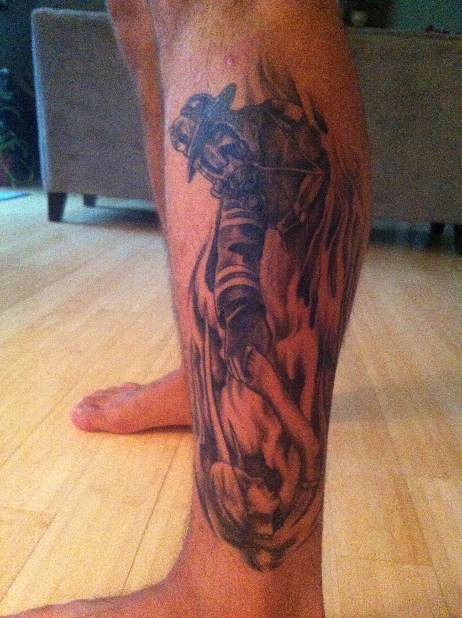 Black And Grey Firefighter Tattoo On Left Leg