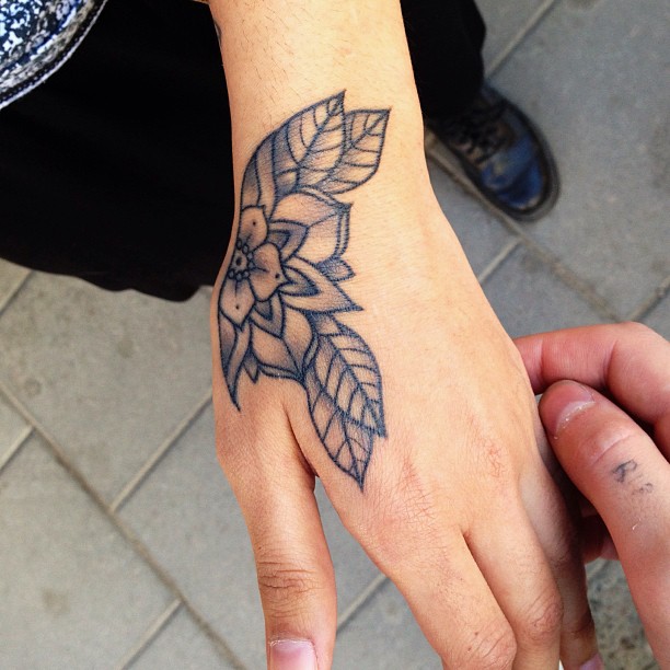 Black And Grey Floral Tattoo On Hand