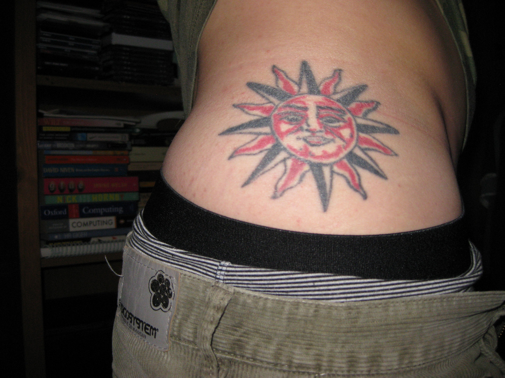 Black And Red Tribal Taino Sun Tattoo On Side Rib