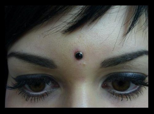 Black Gem Bindi Piercing On Girl Forehead