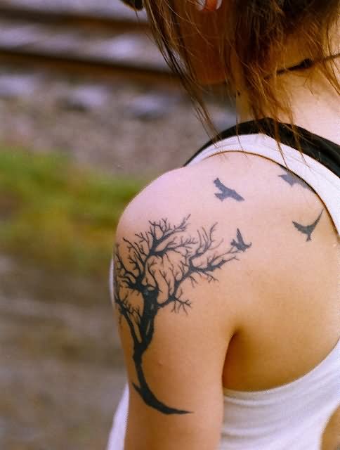 Black Halloween Tree With Flying Crow Tattoo On Girl Left Shoulder