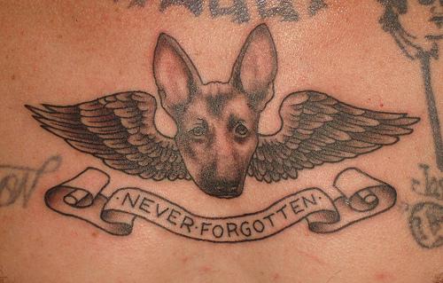 Black Ink Dog Face With Wings And Banner Tattoo Design