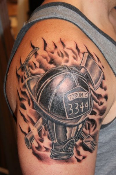 Black Ink Firefighter Helmet With Two Crossing Axe Tattoo On Man Right Shoulder