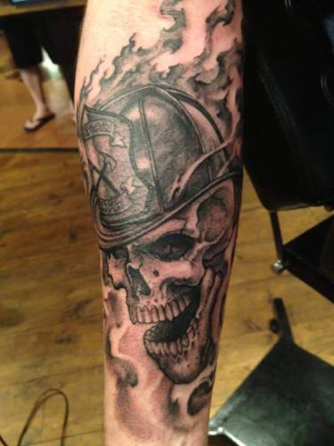 Black Ink Firefighter Skull Tattoo Design For Forearm