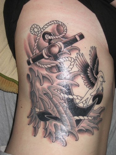 Black Ink Sailor Anchor With Flying Bird Tattoo On Sid Rib