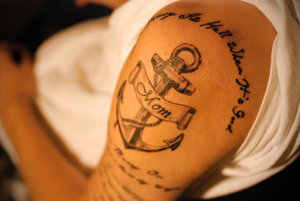 Black Ink Sailor Anchor With Mom Banner Tattoo On Left Shoulder