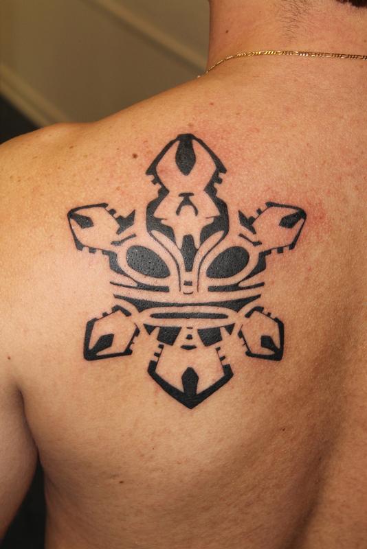 Black Ink Taino Sun Tattoo On Left Back Shoulder