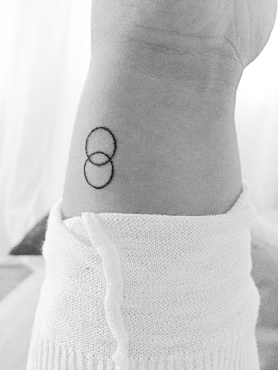 Black Outline Two Circle Tattoo On Wrist