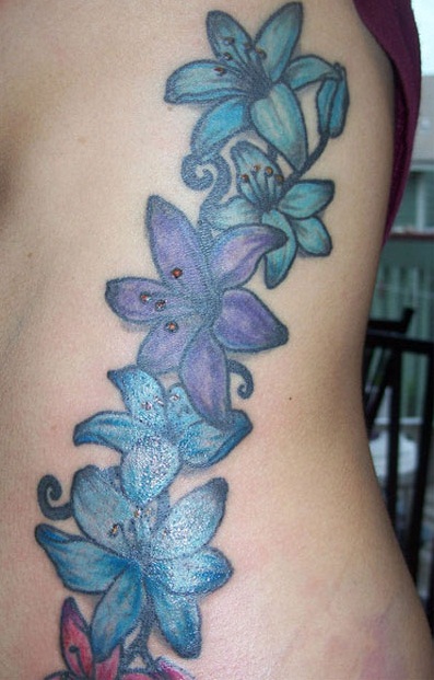Blue And Purple Floral Tattoo Design For Side Rib