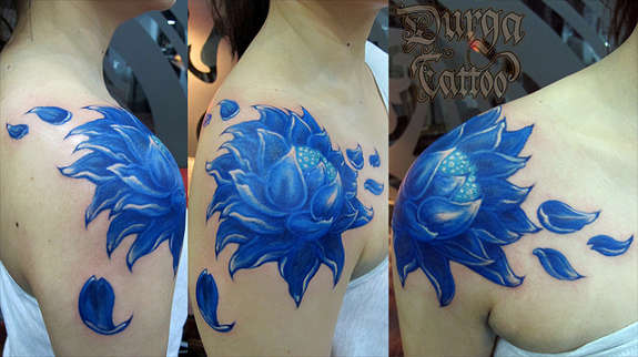 Blue Ink Floral Tattoo On Girl Right Shoulder