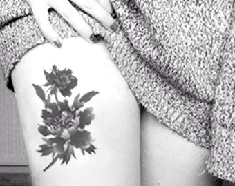 Cool Black Ink Floral Tattoo On Girl Thigh